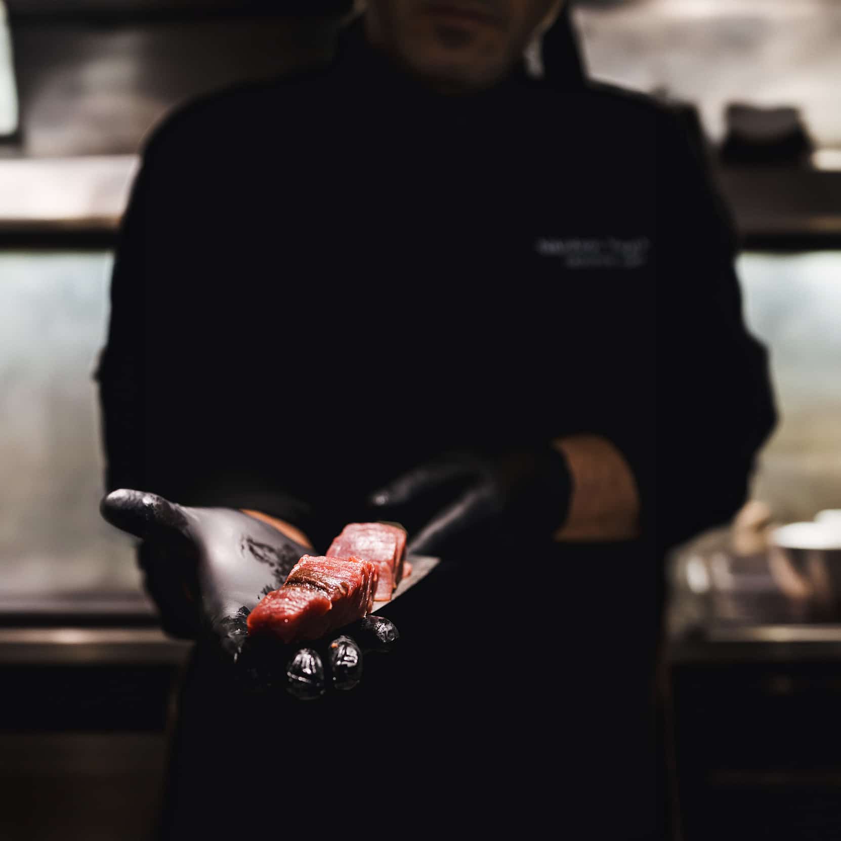 Open kitchen pass with chefs plating dishes at Santana